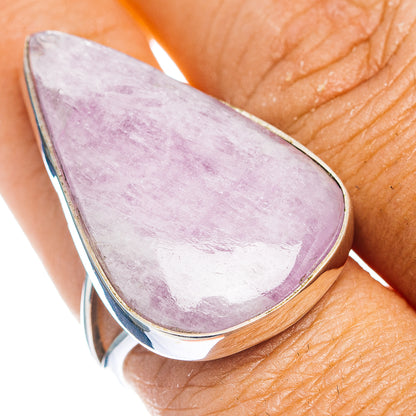 Teardrop kunzite gemstone ring with lilac stone and silver bezel on a finger