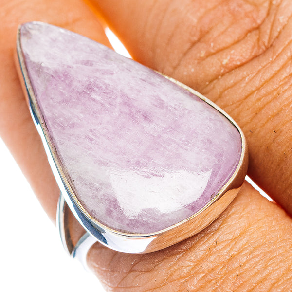Teardrop kunzite gemstone ring with lilac stone and silver bezel on a finger