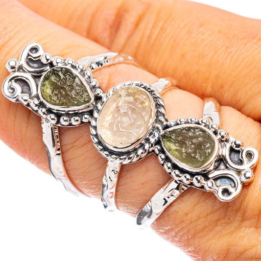 Ornate sterling silver ring with three oval bezel-set stones, worn on finger
