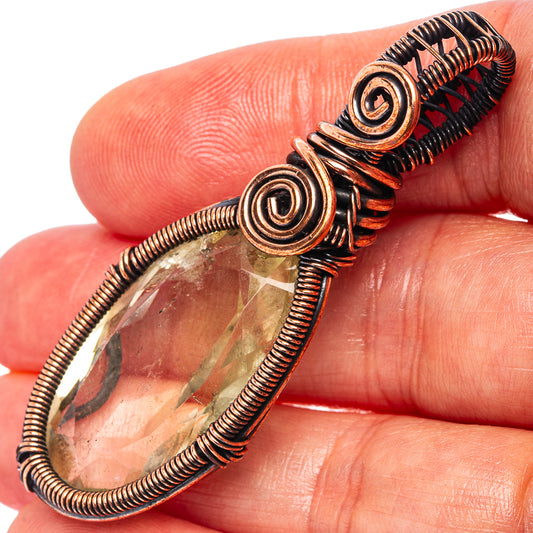 Amethyst wire-wrap pendant with oxidized copper coils and teardrop green stone.