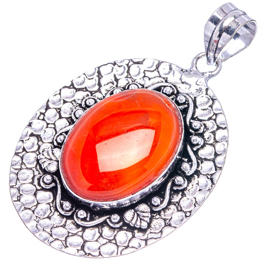 German silver pendant with oval orange-red carnelian cabochon in textured floral frame