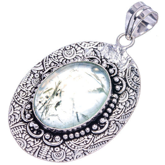 Oval prehnite cabochon pendant in German silver with detailed filigree and hanging bail