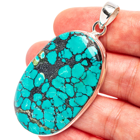 Turquoise oval pendant with black matrix, polished .925 sterling silver bail