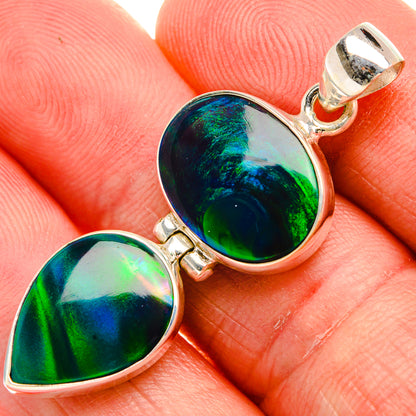 Sterling silver opal pendant with oval iridescent green-blue stone and top bail