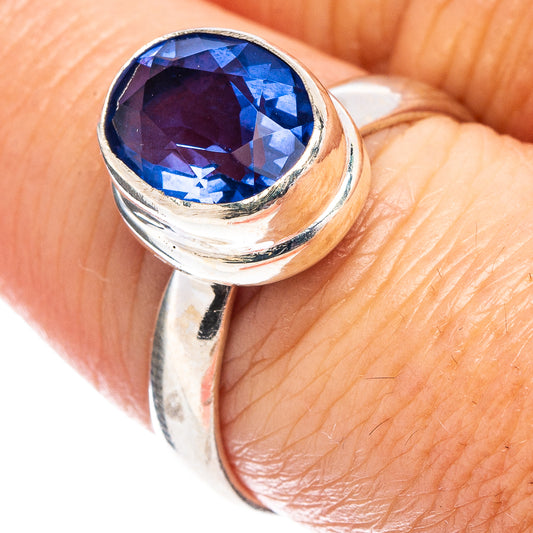 Blue faceted gemstone ring with polished .925 sterling silver band and oval stone