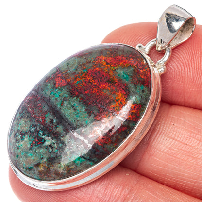 Sterling silver oval pendant with red, teal, and dark stone-like swirl cabochon
