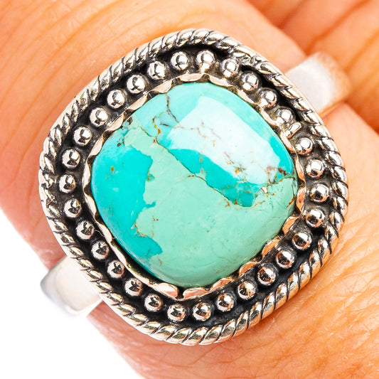 Turquoise cabochon sterling silver ring with beaded halo setting