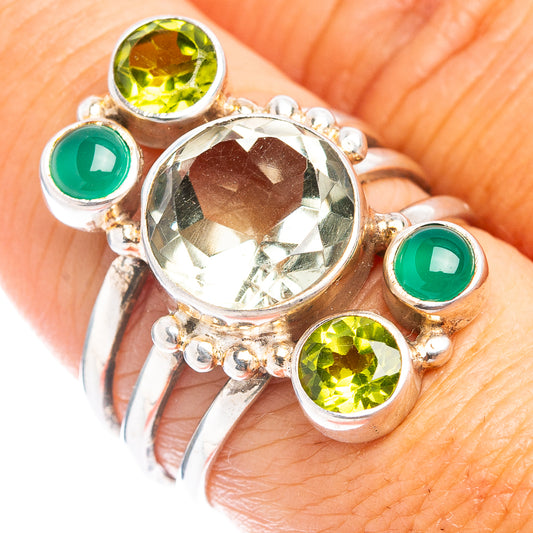 Sterling silver ring with large faceted center stone, green side stones, size 7.25