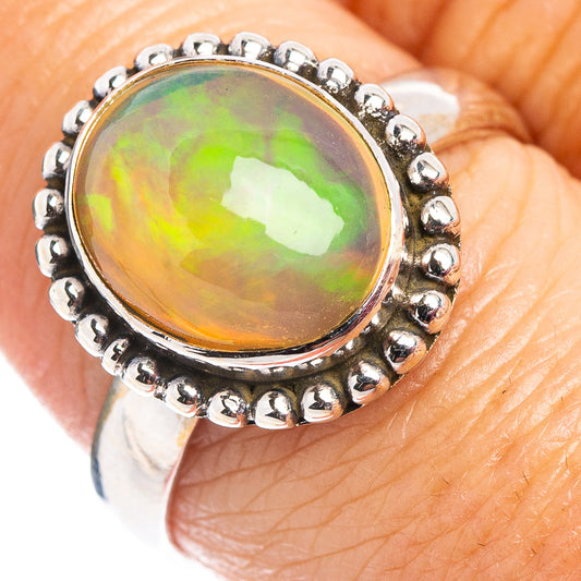 Oval Ethiopian opal ring in .925 sterling silver, bezel-set with bead halo