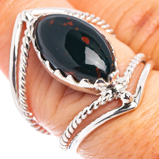 Oval dark stone cabochon ring in .925 sterling silver, braided band and red speckled accents.
