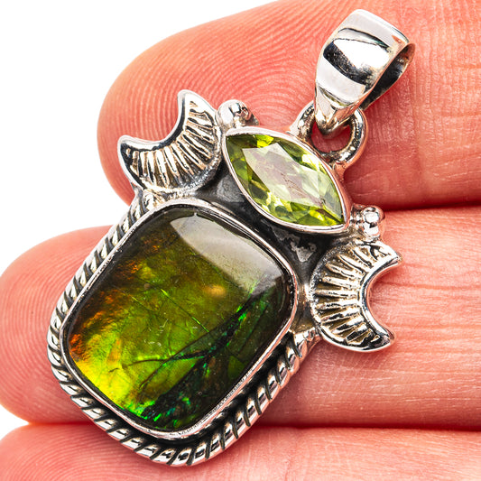 Sterling silver pendant with green pear-shaped gemstone, fish design and bale