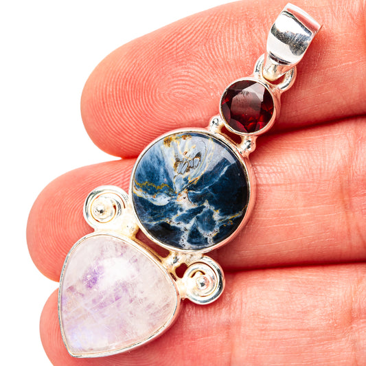 Sterling silver gemstone pendant with round blue stone, red top stone, and pale pear stone