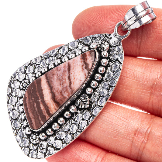 German silver pendant with oval coconut jasper, bezel framed by textured beadwork