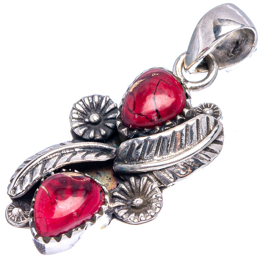 Sterling silver pendant with red teardrop stones, floral accents, and hanging loop