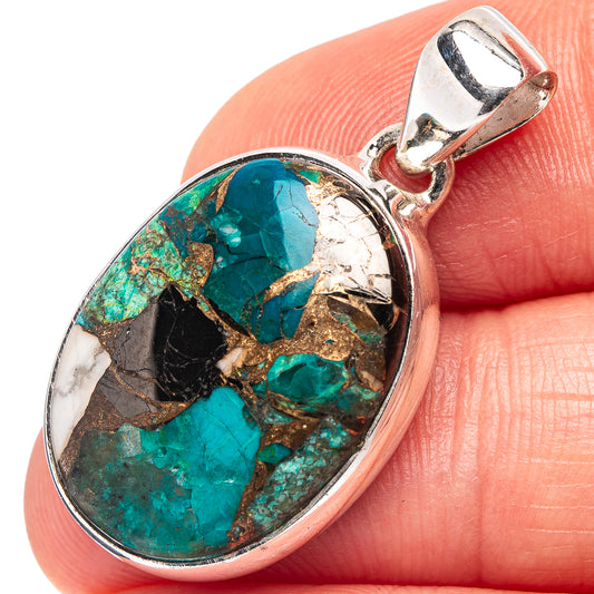Chrysocolla matrix oval pendant on sterling bail, viewed from side on fingertip.