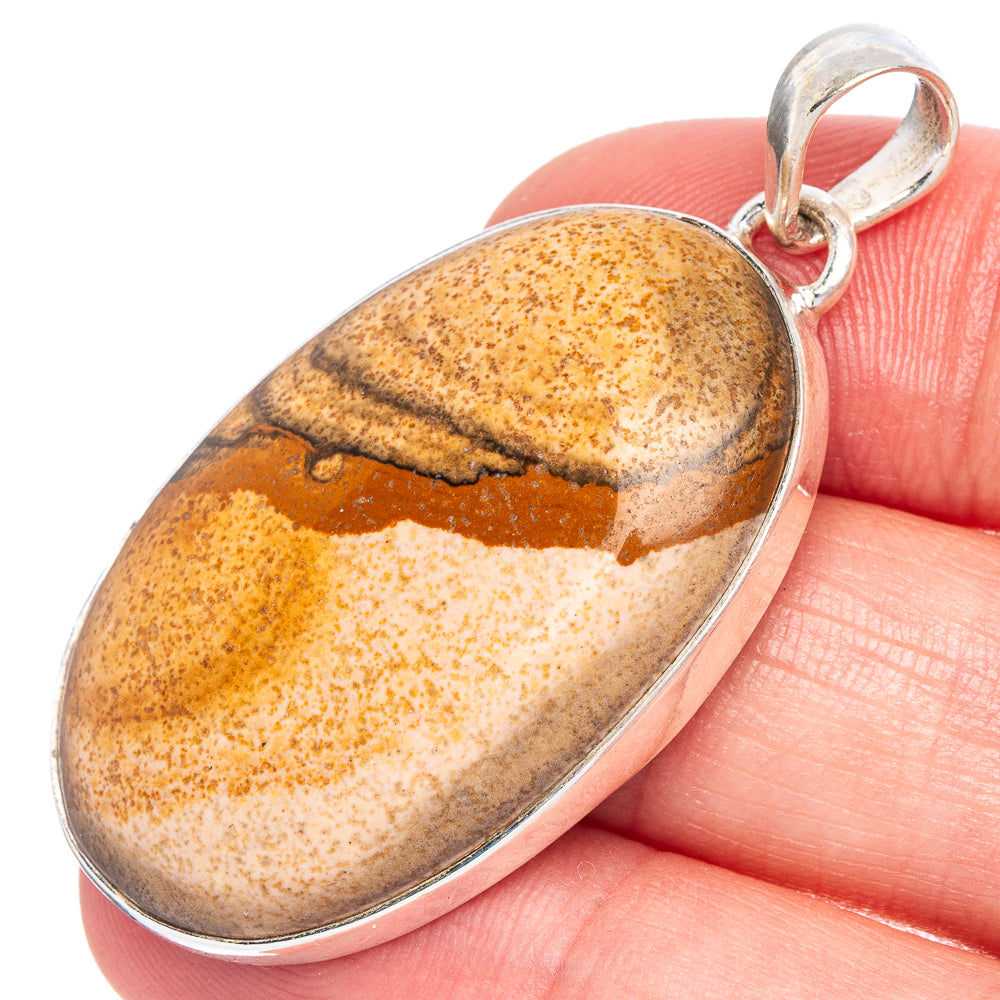 Picture jasper oval pendant with sterling silver frame and bail, banded amber and cream.