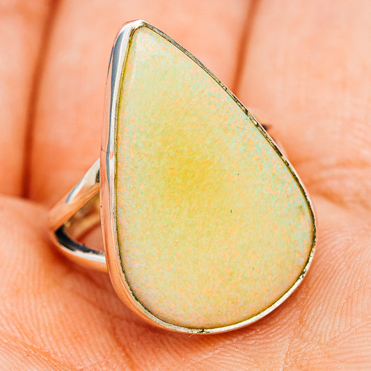 Sterling silver teardrop opal ring, side view with pearlescent yellow-green stone