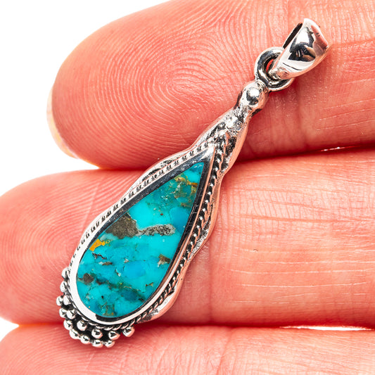 Turquoise teardrop pendant in .925 sterling silver with ornate bail and setting