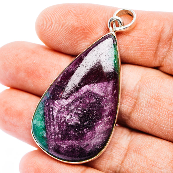 Teardrop gemstone pendant in .925 sterling silver with purple and green stone.