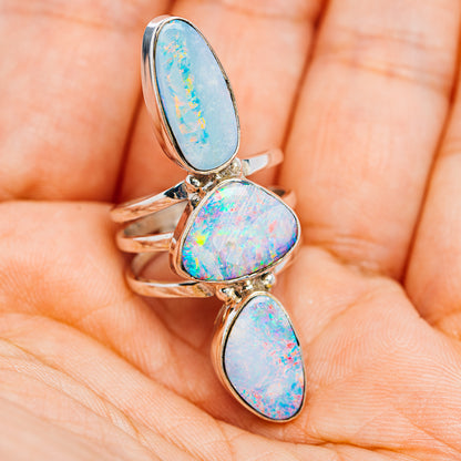 Three-stone sterling silver fire opal ring, oval sky-blue and iridescent cabochons