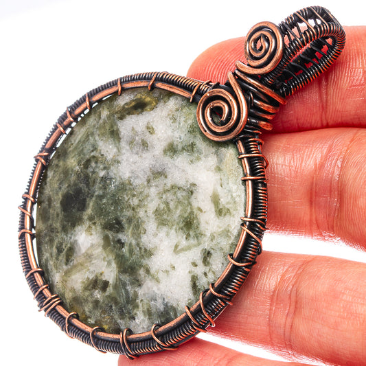 Seraphinite oval pendant close-up: oxidized copper wire wrap with spiral details