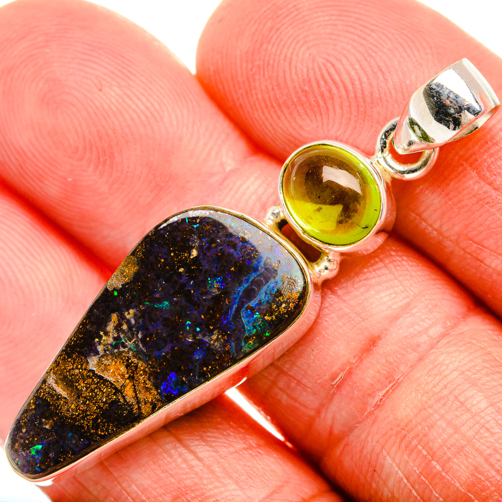 Sterling silver pendant with dark opal stone and round green peridot in bezel