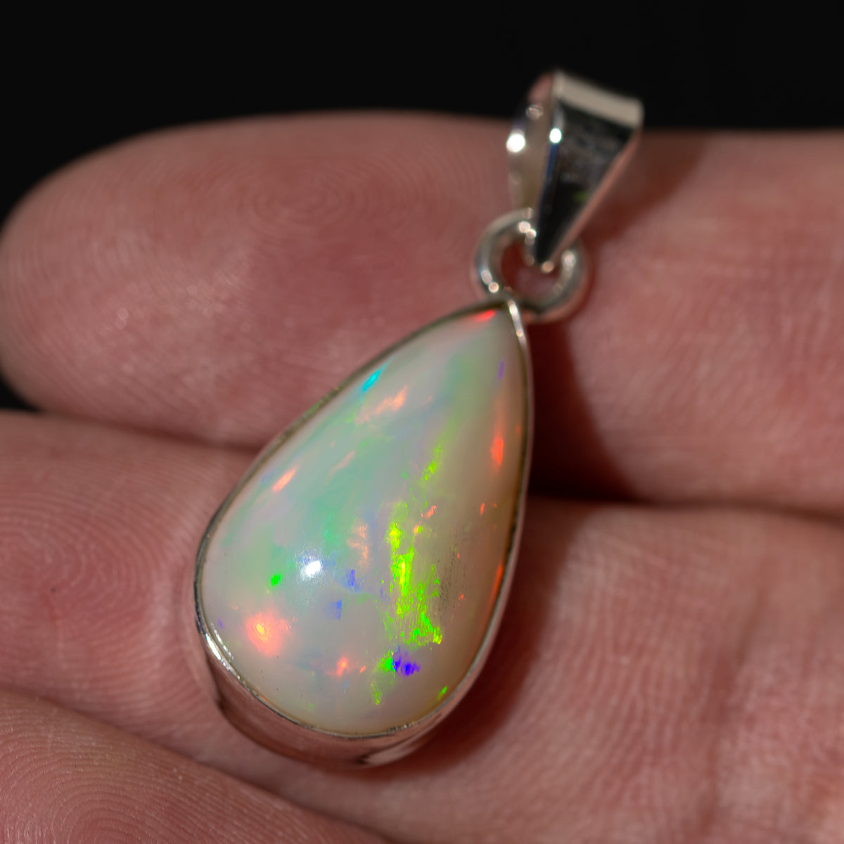 925 sterling silver opal teardrop pendant with colorful rainbow glow