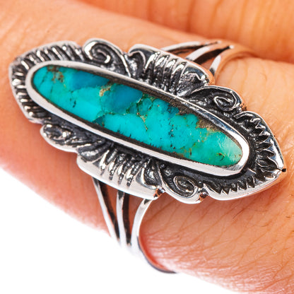 Silver turquoise oval ring with ornate border and raised setting