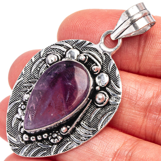 Amethyst pendant in German silver with oval purple stone and ornate filigree frame