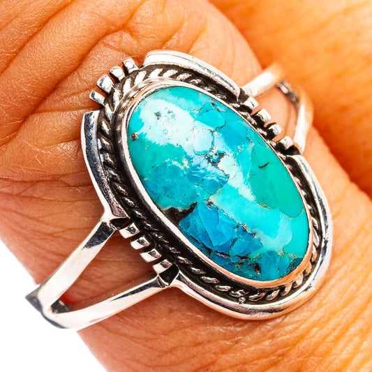 Oval turquoise cabochon sterling silver ring with engraved bezel and braided edges