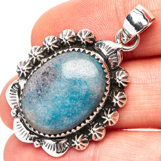 Oval apatite pendant in .925 sterling silver with blue stone and detailed floral bezel