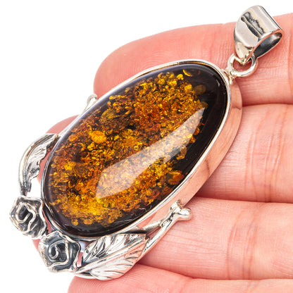 Sterling silver pendant with oval Baltic amber cabochon in dark honey tones and silver bail