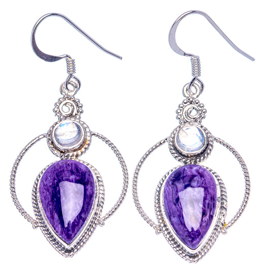 Sterling silver dangle earrings with purple pear stones, linked halos, and opalescent round tops