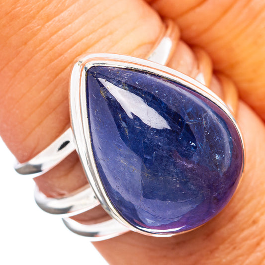Sterling silver ring with oval blue-violet gemstone center and curved band