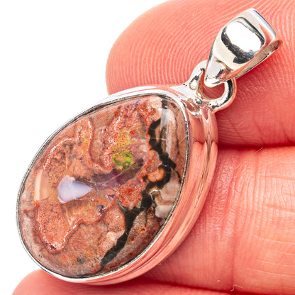 Sterling silver fire opal pendant with oval red-and-brown stone cabochon in bezel