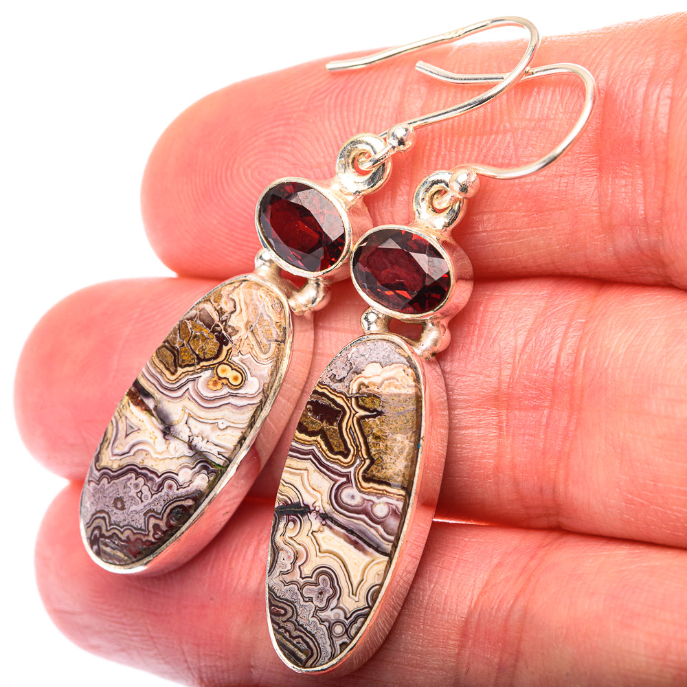Sterling silver drop earrings with marbled oval stones and red garnet tops