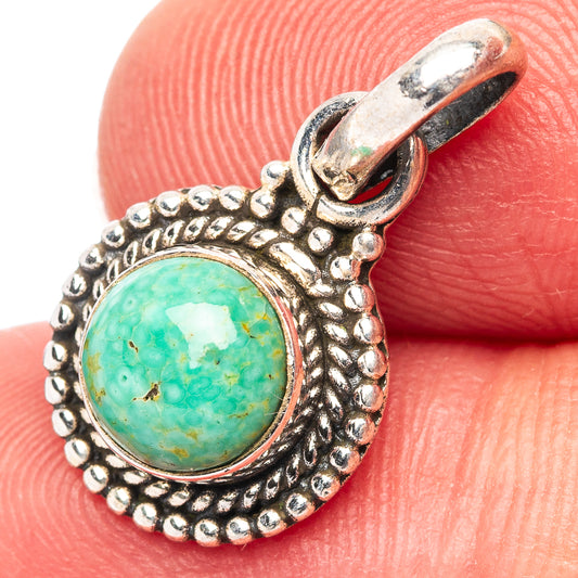 Turquoise round pendant with beaded sterling silver teardrop frame.