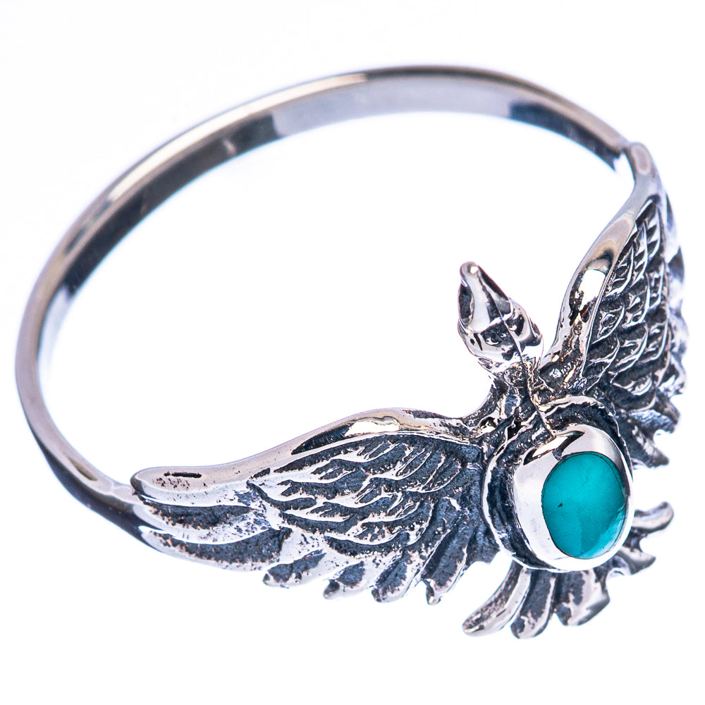 Silver bird ring with turquoise oval cabochon and detailed wing feathers, side view