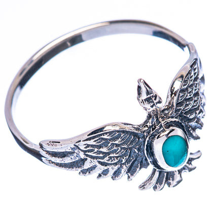 Silver bird ring with turquoise oval cabochon and detailed wing feathers, side view
