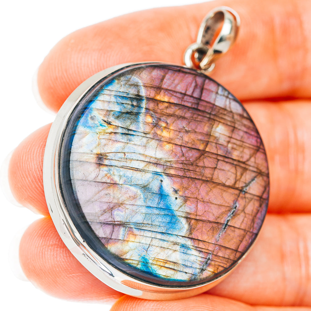 Round labradorite pendant with iridescent blue and purple facets, German silver bezel