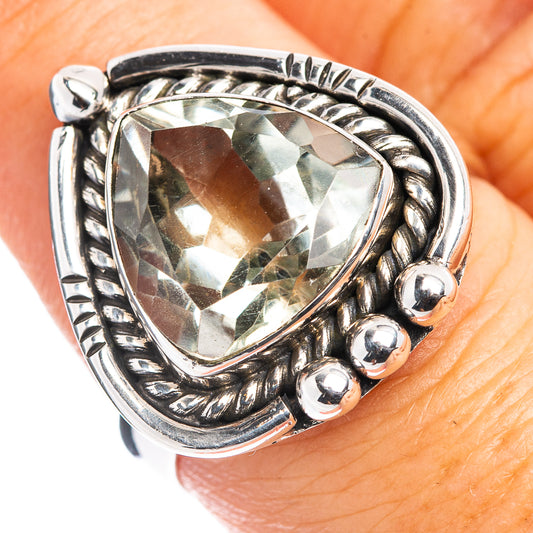 Sterling silver ornate ring with pale green faceted centerpiece, beadlike side accents