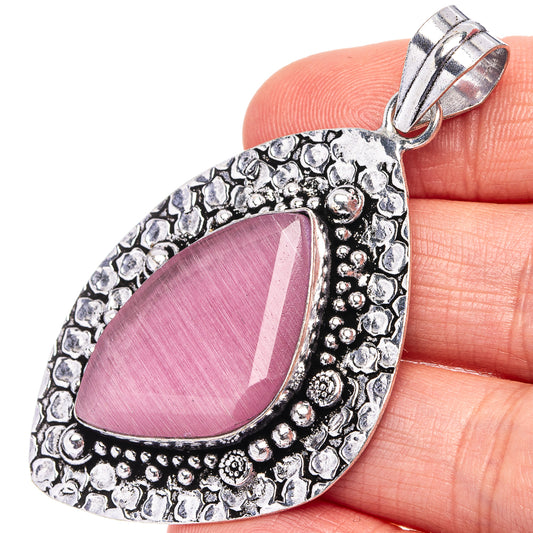 Pink onyx teardrop pendant in German silver with ornate beaded border