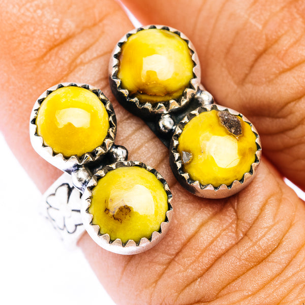 Sterling silver ring with four yellow cabochon stones in scalloped settings