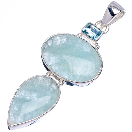 Sterling silver pendant with two light blue gemstones, leaf and teardrop shapes, angled view