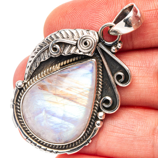 Sterling silver moonstone pendant with teardrop cabochon and ornate side accents