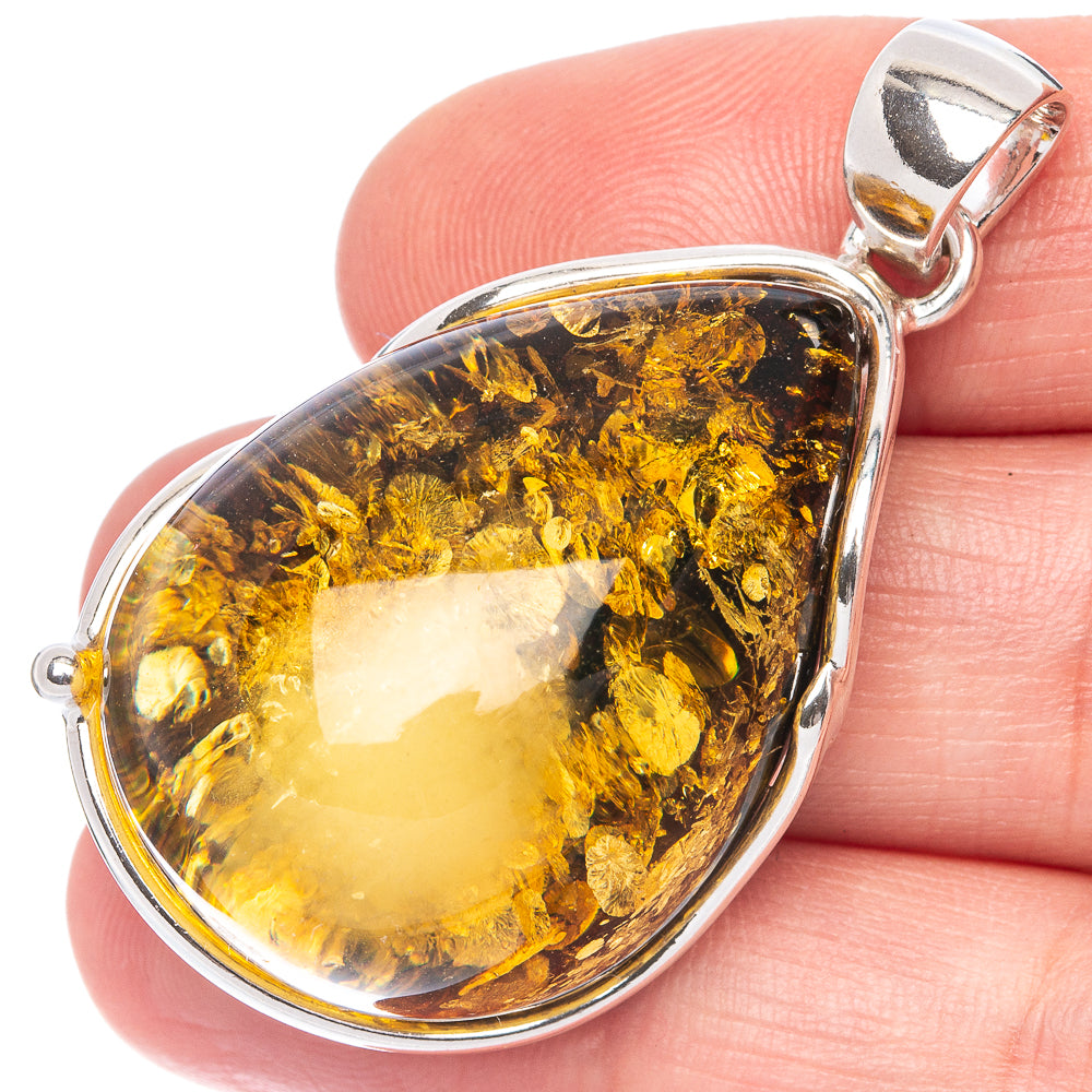 Silver pendant with teardrop amber resin stone, polished bail and frame