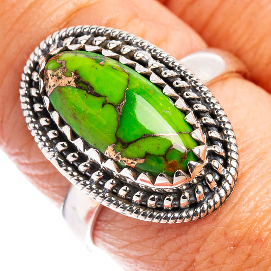 Sterling silver ring with green turquoise cabochon, size 8.5, ornate border.