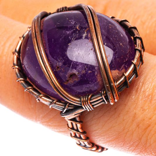 Amethyst gemstone ring with oxidized copper wire wrap and oval purple stone