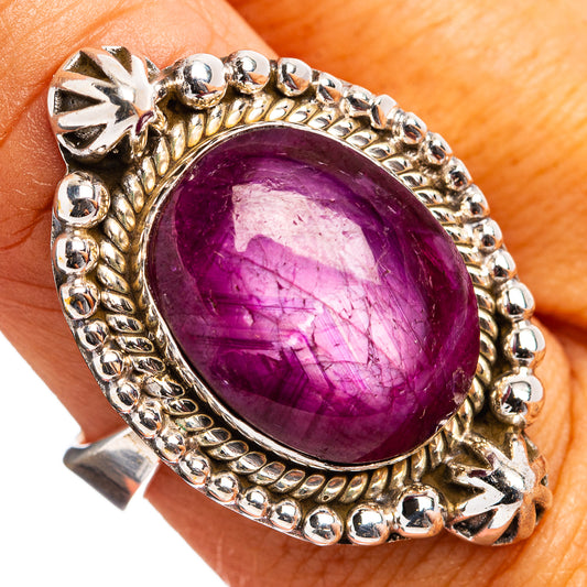 Sterling silver ring with oval purple gemstone and decorative beaded bezel