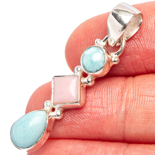 Sterling silver gemstone pendant close-up: blue oval and pink square opal stones